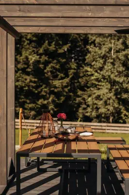 a room with a table and chairs and a television at Honey House Wierchy- prywatna strefa SPA in Jaszczurowa