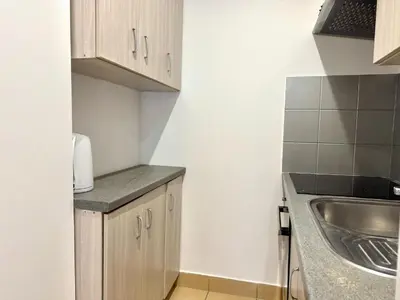 a small kitchen with a sink and a counter at Apartament Zagrodowa in Oświęcim