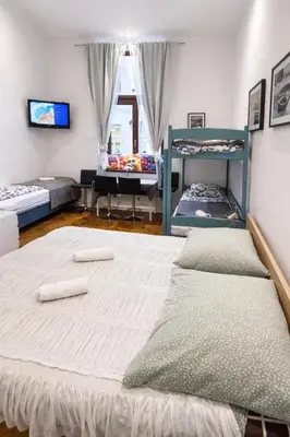 a bedroom with a bed and a table in it at CityGate Kraków in Kraków