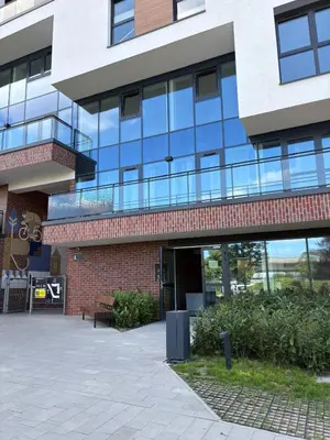 a park bench in front of a building at Aparthotel Rakowicka - Kraków Stare Miasto in Kraków