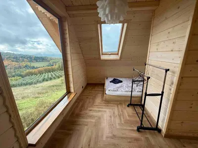 a small room with a bed and a window at Slow Mountains in Wola Piskulina