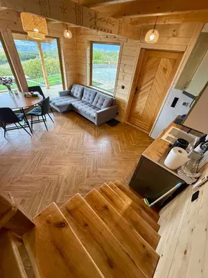 a living room with a couch and a table at Slow Mountains in Wola Piskulina