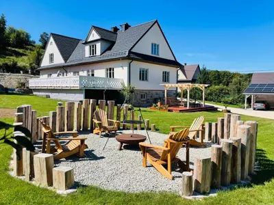 a playground with chairs and a table and a house at Villa Pippi in Tokarnia