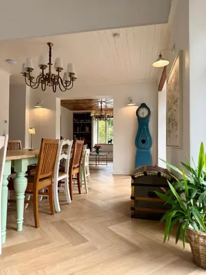 a dining room with a table and a blue vase at Villa Pippi in Tokarnia