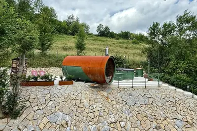 a large barrel sitting on top of a stone ground at Villa Pippi in Tokarnia