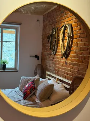 a bed in a room with a brick wall at Villa Pippi in Tokarnia