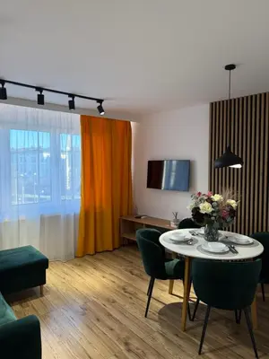 a living room with a table and chairs at Kraków Cozy Spot Center in Kraków