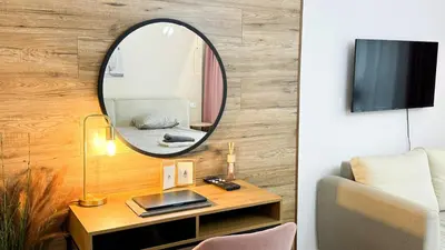 a living room with a mirror and a table at Kraków Cozy Spot Center in Kraków