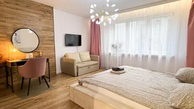 a bedroom with a bed and a chair and a mirror at Kraków Cozy Spot Center in Kraków