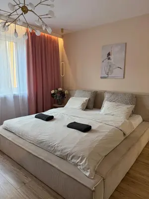 a large bed in a bedroom with two towels on it at Kraków Cozy Spot Center in Kraków