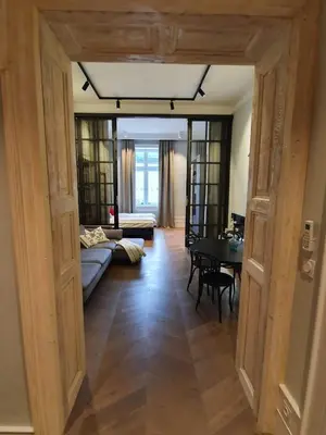 a living room with a couch and a table at Stradom Apartments by Noah in Kraków