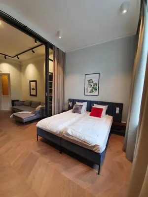a bedroom with a bed and a living room at Stradom Apartments by Noah in Kraków