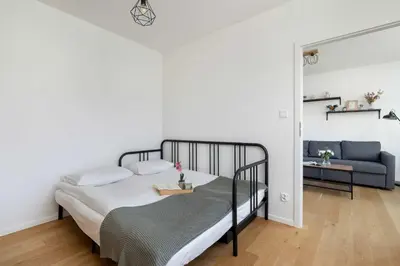 a bedroom with a bed and a couch at Functional Apartment with Parking in Cracow by Noclegi Renters in Kraków