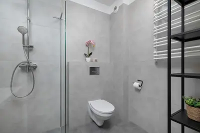 a bathroom with a shower and a toilet in it at Functional Apartment with Parking in Cracow by Noclegi Renters in Kraków