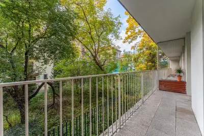 a balcony with a fence and trees at Cracow Home Harmony Apartment by BookingHost in Kraków