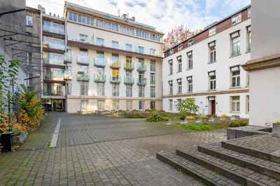 an empty street in front of buildings at Cracow Home Harmony Apartment by BookingHost in Kraków