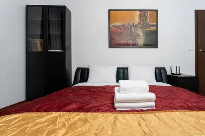 a bedroom with a bed with two towels on it at Cracow Home Harmony Apartment by BookingHost in Kraków