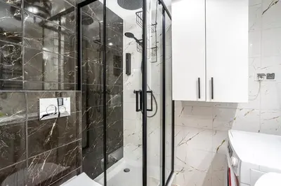 a bathroom with a shower with a glass door at Charming Kazimierz Studio near Wawel in Kraków