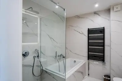 a bathroom with a shower and a glass shower stall at K16 Apartments in Kraków