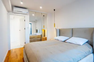 a bedroom with a large bed with two pillows at K16 Apartments in Kraków