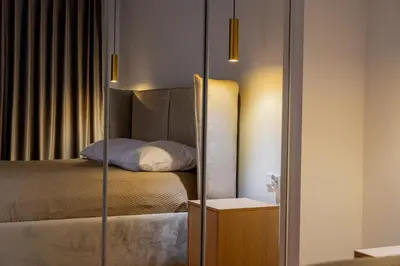 a bedroom with a bed with a glass door at K16 Apartments in Kraków