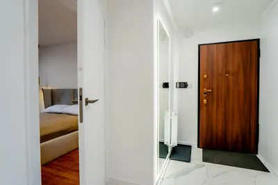 a room with a door leading to a bedroom at K16 Apartments in Kraków
