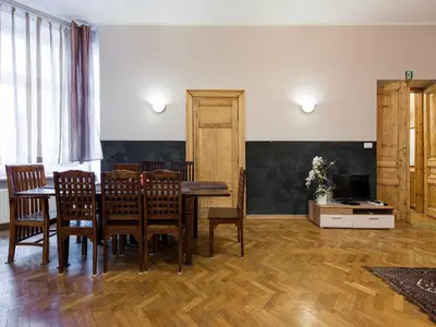 a dining room with a table and chairs at 5 Bedroom Family Apartment in Kraków