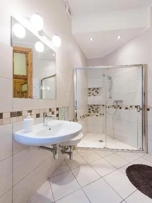 a bathroom with a sink and a shower at 5 Bedroom Family Apartment in Kraków
