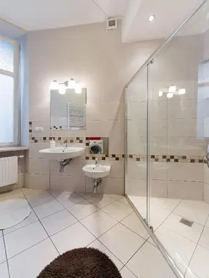 a bathroom with two sinks and a shower at 5 Bedroom Family Apartment in Kraków