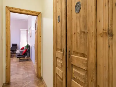 a hallway with a wooden door in a room at 5 Bedroom Family Apartment in Kraków