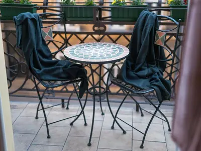 a table and two chairs with coats on them at 5 Bedroom Family Apartment in Kraków