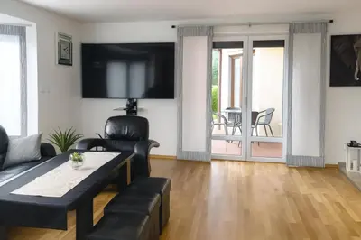 a living room with a couch and a table at Dworek pod Jeżową Wodą in Młyńczyska