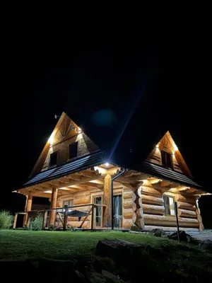 a log cabin with lights on it at night at Zawojenka in Zawoja