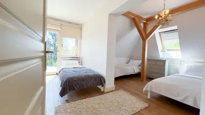 a bedroom with two beds and a window at Golden Villas - Elegant Family Villa with Garden near Krakow in Węgrzce
