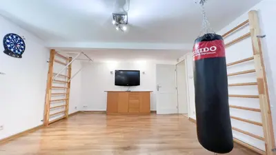 a room with a punching bag hanging from the ceiling at Golden Villas - Elegant Family Villa with Garden near Krakow in Węgrzce