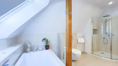 a white bathroom with a shower and a toilet at Golden Villas - Elegant Family Villa with Garden near Krakow in Węgrzce