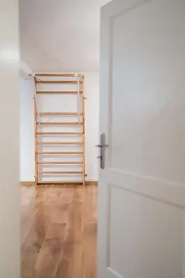 an open door to a room with a wooden floor at Golden Villas - Elegant Family Villa with Garden near Krakow in Węgrzce