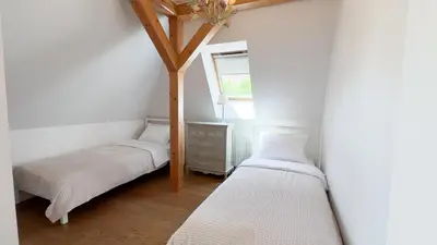 two twin beds in a room with a window at Golden Villas - Elegant Family Villa with Garden near Krakow in Węgrzce