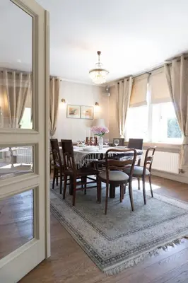 a dining room with a table and chairs at Golden Villas - Elegant Family Villa with Garden near Krakow in Węgrzce