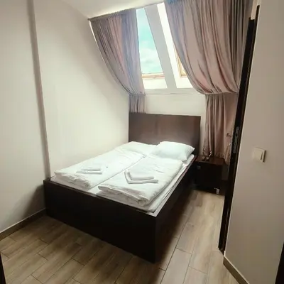 a small bed in a room with a window at Gościniec Tenczyn in Tenczyn