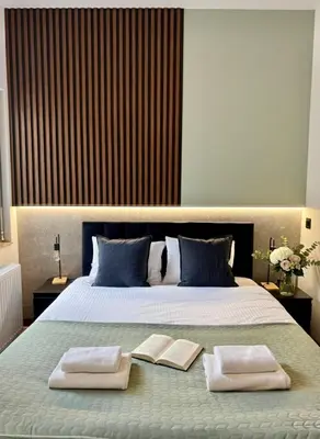 a bedroom with a large bed with two towels on it at Apartament KRAKÓW CENTRUM Smoleńsk 33 in Kraków