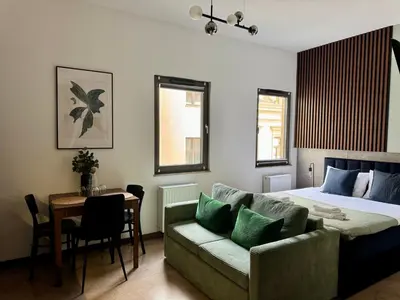 a bedroom with a bed and a couch and a table at Apartament KRAKÓW CENTRUM Smoleńsk 33 in Kraków