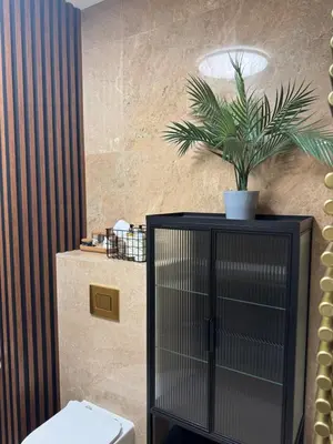 a bathroom with a toilet and a plant on the wall at Apartament KRAKÓW CENTRUM Smoleńsk 33 in Kraków