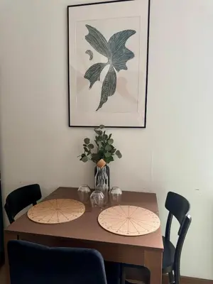 a dining room table with two chairs and a picture at Apartament KRAKÓW CENTRUM Smoleńsk 33 in Kraków