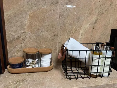 a basket filled with toiletries sitting next to a wall at Apartament KRAKÓW CENTRUM Smoleńsk 33 in Kraków