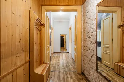 a hallway with wood paneling and a mirror at Native Apartments Krasińskiego 21 in Kraków