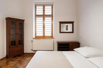 a white room with two beds and a window at Native Apartments Krasińskiego 21 in Kraków