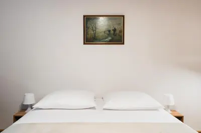 a bedroom with a bed with a painting on the wall at Native Apartments Krasińskiego 21 in Kraków