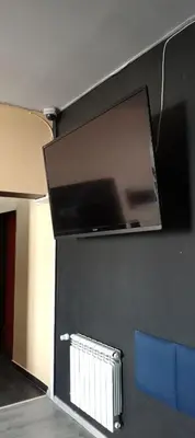 a flat screen tv hanging on a wall at Rembrandt Hostel in Kraków