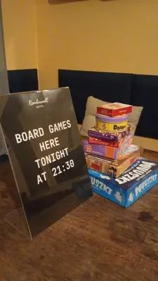 a sign sitting on top of a stack of books at Rembrandt Hostel in Kraków